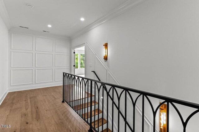 interior space with light hardwood / wood-style floors and ornamental molding