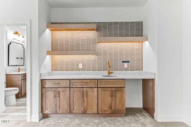 kitchen featuring light colored carpet and sink