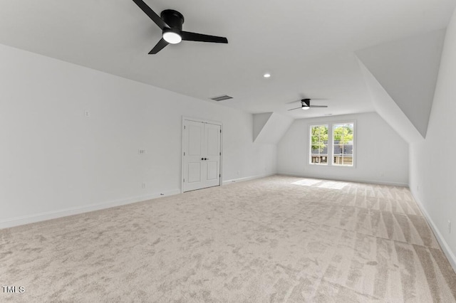 additional living space with ceiling fan, lofted ceiling, and light carpet