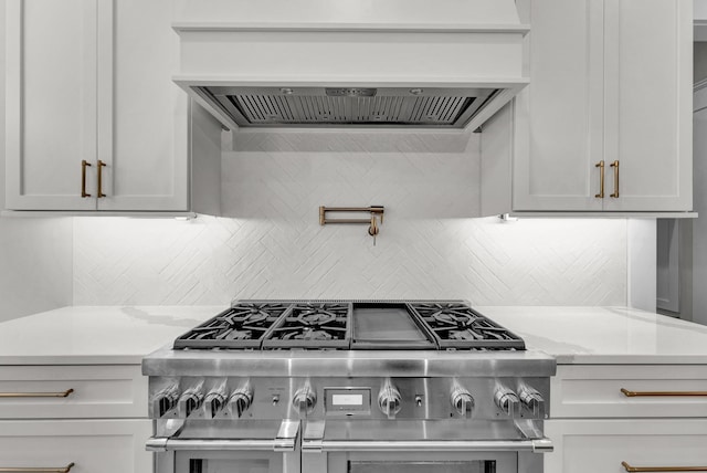 kitchen with premium range hood, tasteful backsplash, double oven range, and light stone counters