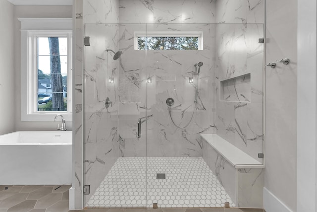 bathroom with plenty of natural light, separate shower and tub, and tile flooring