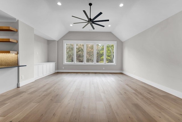 spare room featuring lofted ceiling, light hardwood / wood-style flooring, and ceiling fan