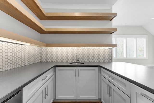 kitchen with white cabinets, tasteful backsplash, dishwasher, and sink