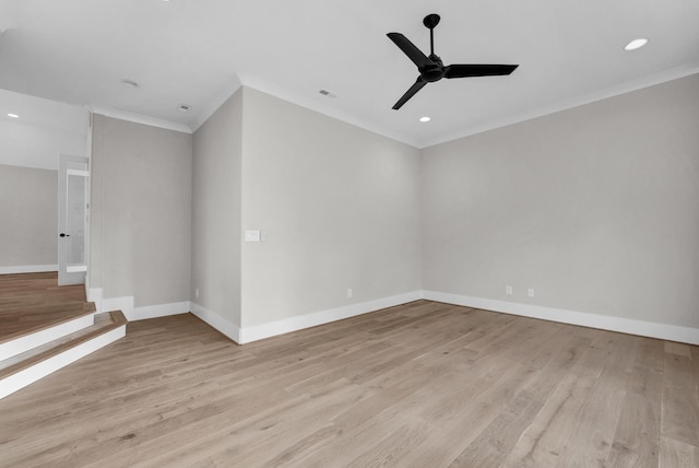 spare room featuring light hardwood / wood-style floors, ceiling fan, and ornamental molding