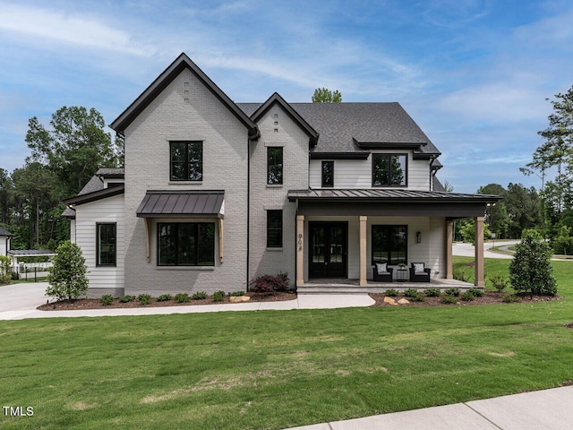 modern farmhouse style home featuring a patio area and a front lawn