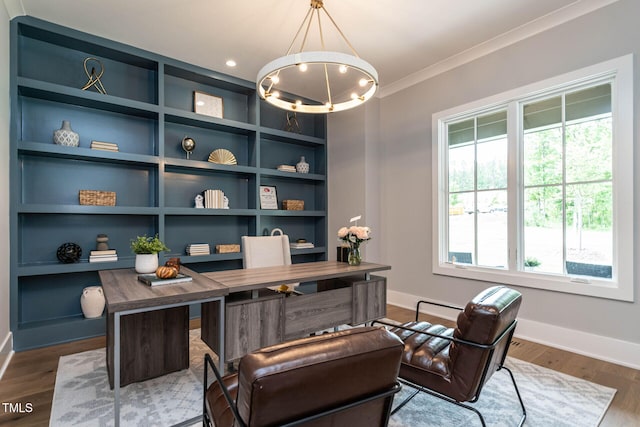 office space featuring ornamental molding, hardwood / wood-style flooring, and an inviting chandelier