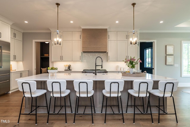 kitchen featuring a large island, a breakfast bar, pendant lighting, and dark hardwood / wood-style floors