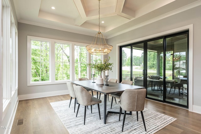 dining area featuring coffered ceiling, hardwood / wood-style floors, ornamental molding, and an inviting chandelier