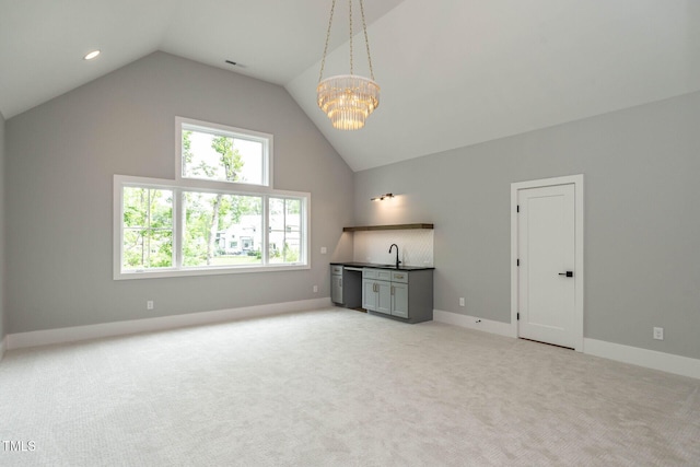 additional living space with lofted ceiling, a chandelier, light carpet, and sink