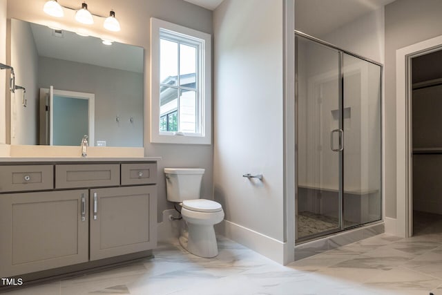 bathroom with a shower with door, toilet, and vanity