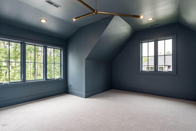 additional living space featuring lofted ceiling, a wealth of natural light, and carpet floors