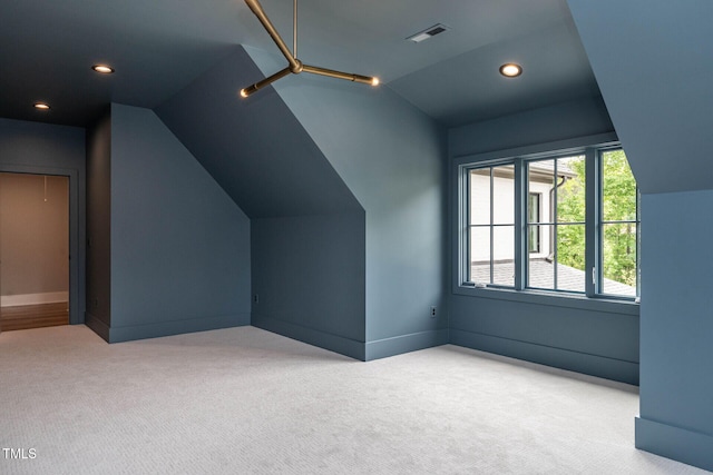 bonus room with light carpet and lofted ceiling