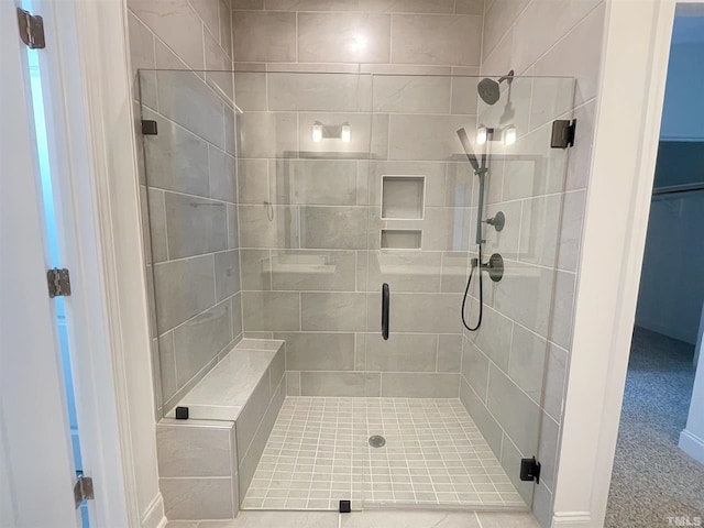 bathroom with a shower with door