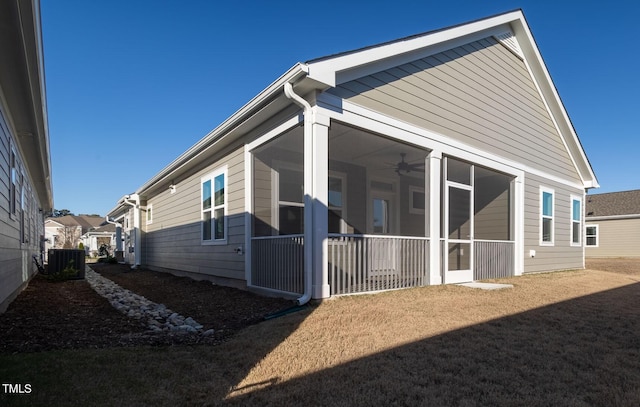 view of property exterior featuring central AC and a yard