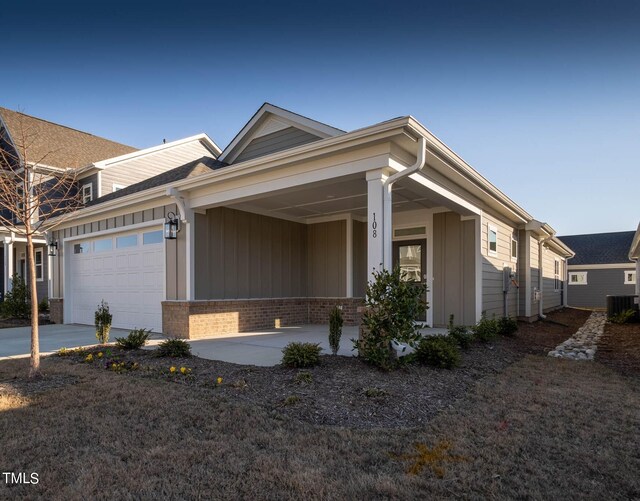 view of front of house featuring a garage and central air condition unit