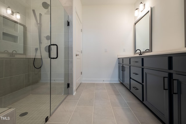 bathroom featuring tile floors, a shower with door, dual sinks, and large vanity