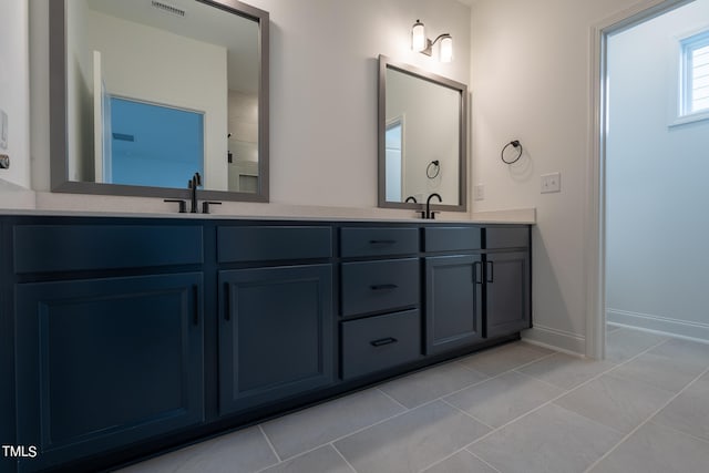 bathroom featuring tile flooring and dual vanity