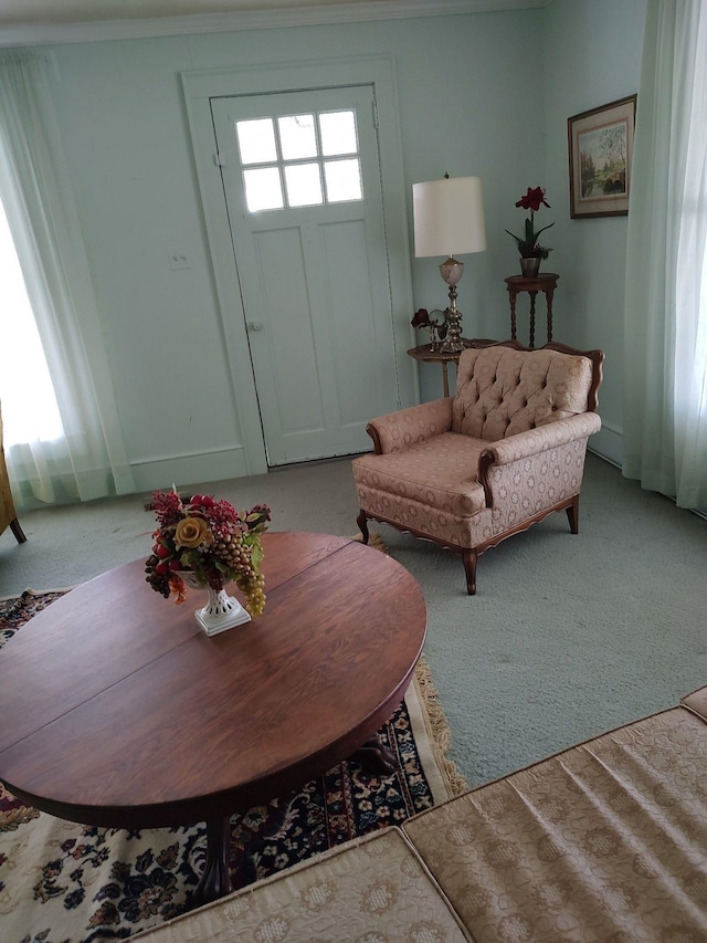 carpeted living room with crown molding