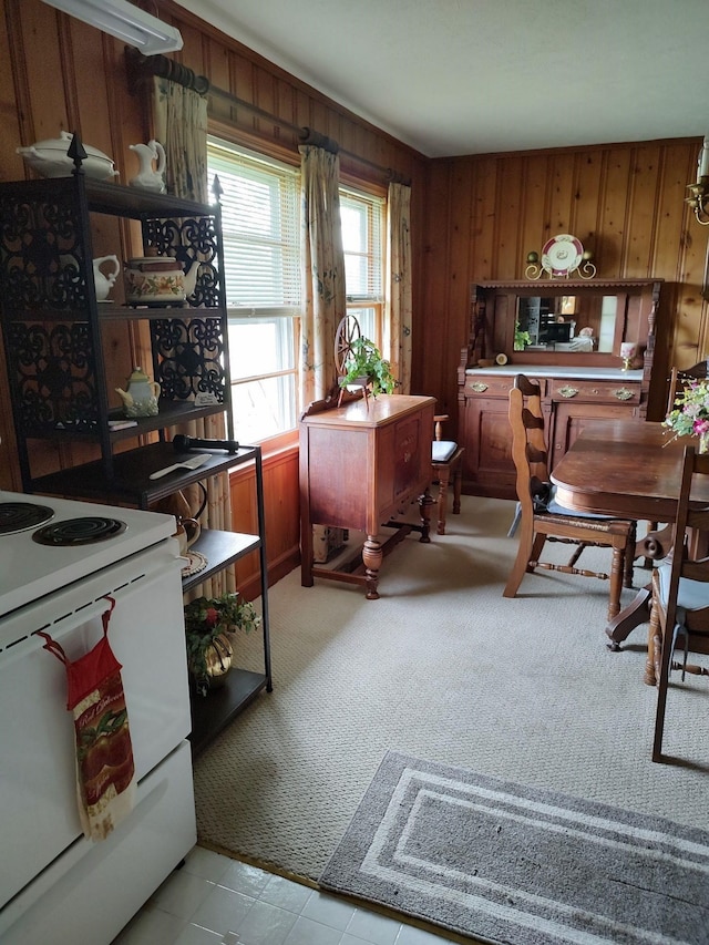 carpeted home office with wood walls