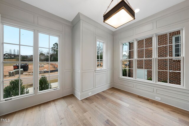 unfurnished sunroom featuring a healthy amount of sunlight