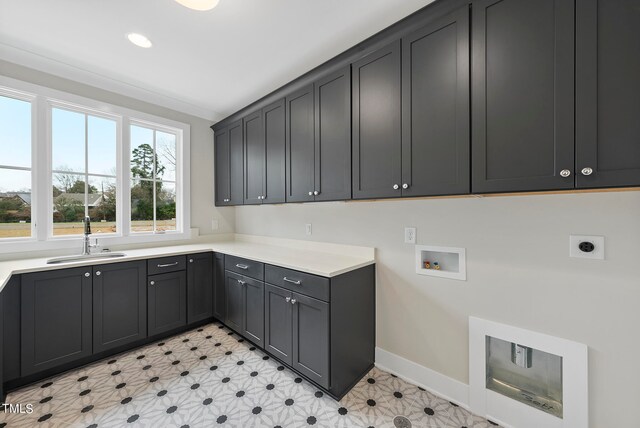 washroom with hookup for a washing machine, cabinets, sink, and electric dryer hookup