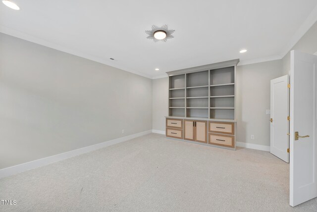 carpeted spare room featuring ornamental molding