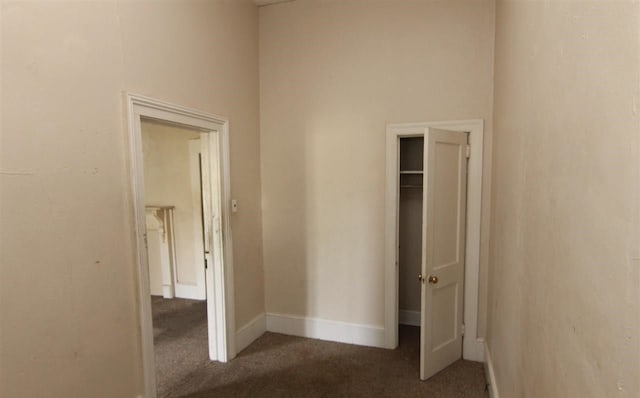 unfurnished bedroom featuring carpet flooring and a closet