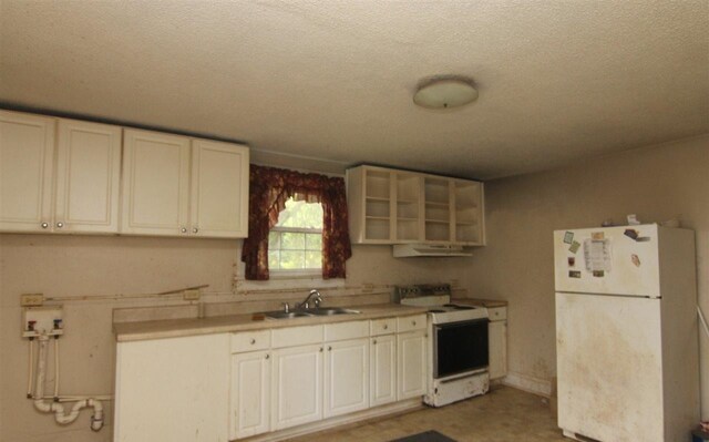 kitchen featuring a textured ceiling, white appliances, white cabinetry, and sink