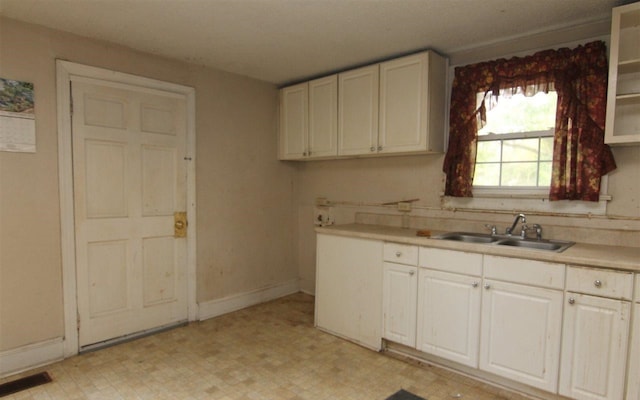 kitchen featuring white cabinets and sink