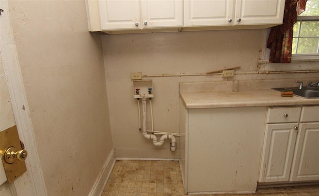 clothes washing area featuring cabinets, sink, and hookup for a washing machine