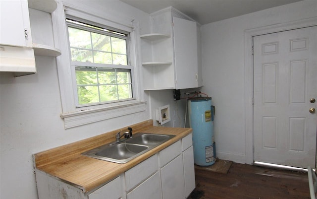 kitchen with water heater, sink, and white cabinets