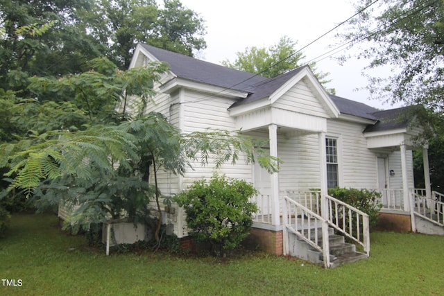 view of side of home featuring a yard