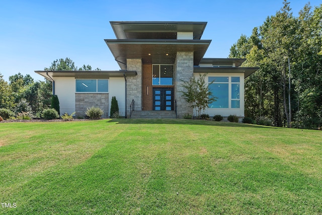 view of front of property with stone siding and a front lawn