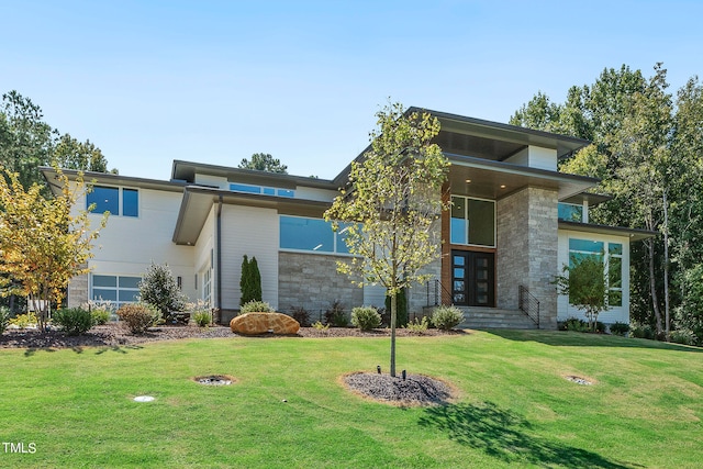 view of front of property featuring stone siding and a front lawn