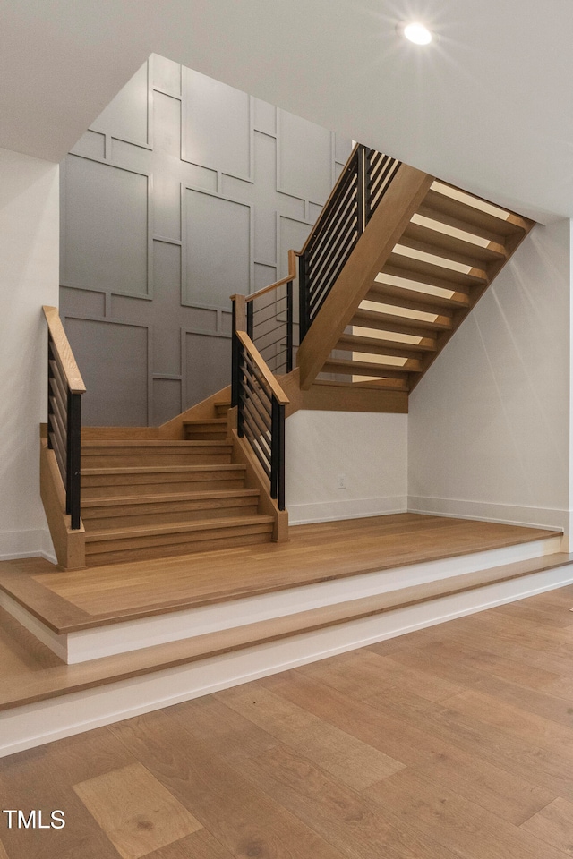 stairs with baseboards and wood finished floors