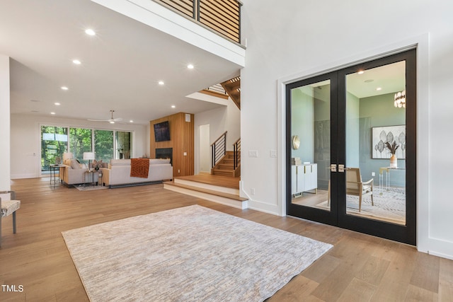 entryway featuring french doors, stairway, light wood-style flooring, and recessed lighting