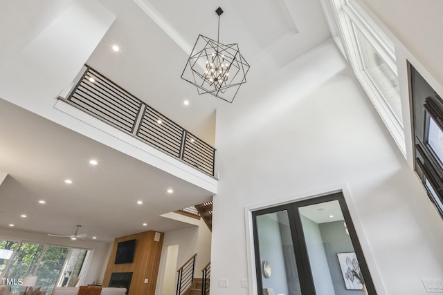 details featuring recessed lighting, a fireplace, and ceiling fan with notable chandelier