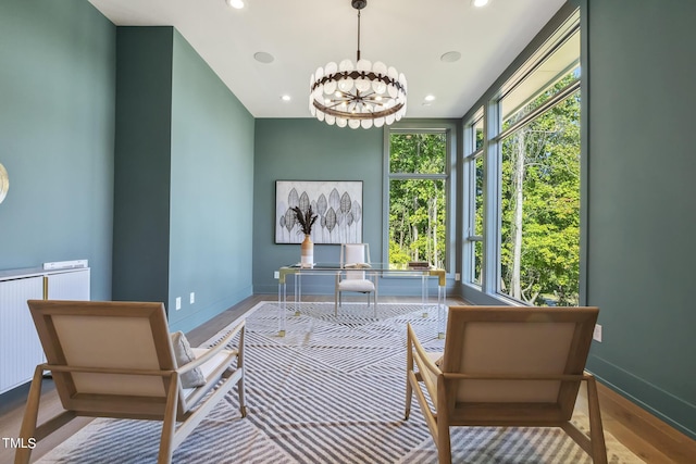 interior space featuring an inviting chandelier, radiator heating unit, wood finished floors, and recessed lighting