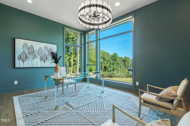 office space featuring baseboards, a notable chandelier, wood finished floors, and recessed lighting