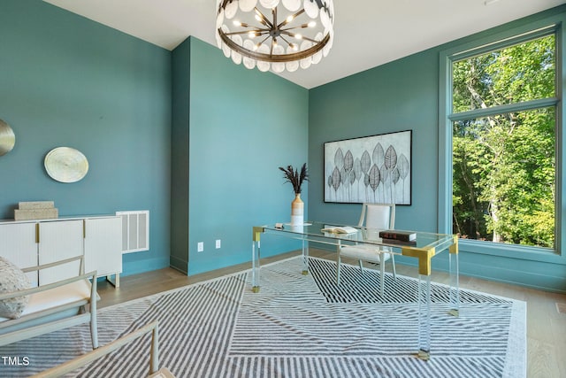 office area with a healthy amount of sunlight, baseboards, visible vents, and a chandelier