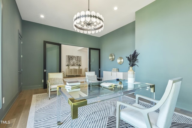 dining space featuring a notable chandelier, recessed lighting, baseboards, and wood finished floors