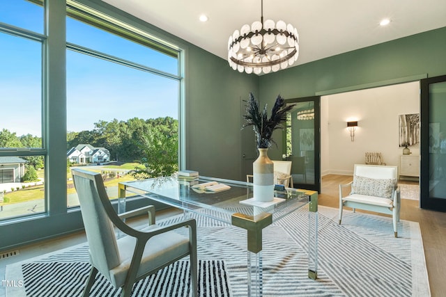 dining area featuring baseboards, visible vents, wood finished floors, a notable chandelier, and recessed lighting