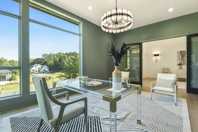 dining area with wood finished floors, visible vents, baseboards, recessed lighting, and a notable chandelier