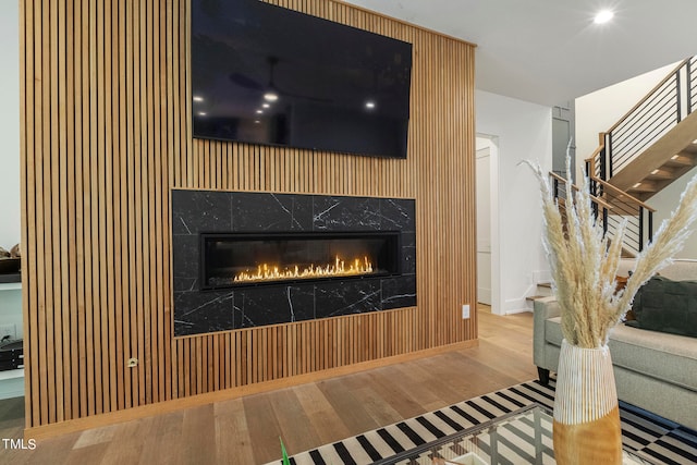 interior details with a fireplace, baseboards, and wood finished floors