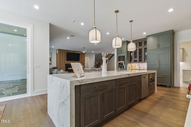 kitchen featuring a ceiling fan, paneled built in fridge, recessed lighting, a sink, and light wood-type flooring