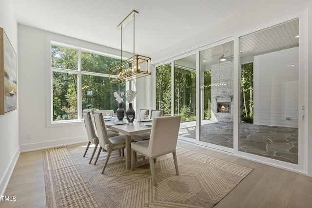 sunroom with a large fireplace and an inviting chandelier