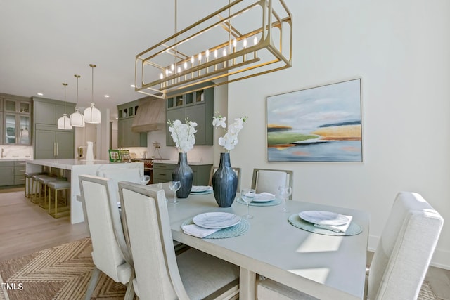 dining space with light wood-type flooring and recessed lighting