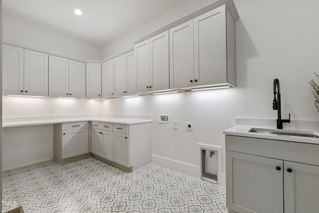 laundry area featuring recessed lighting, hookup for a washing machine, cabinet space, hookup for an electric dryer, and a sink