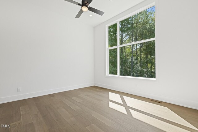 unfurnished room featuring recessed lighting, ceiling fan, baseboards, and wood finished floors