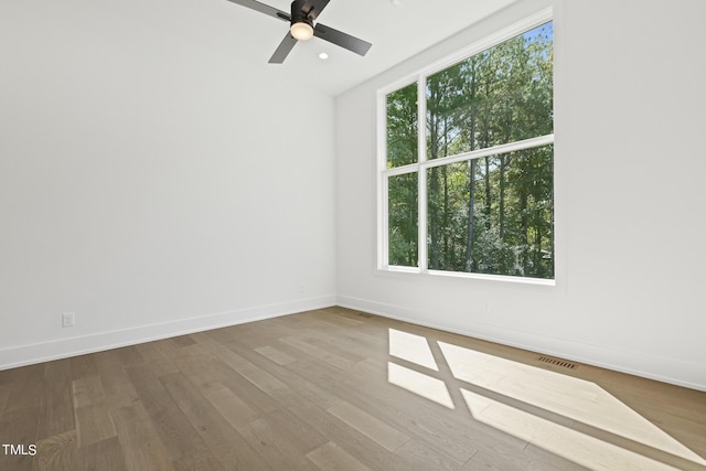 unfurnished room featuring visible vents, a ceiling fan, wood finished floors, recessed lighting, and baseboards